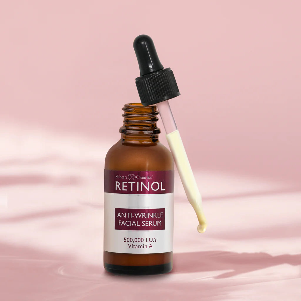 Retinol anti-wrinkle facial serum bottle with dropper on a pink background