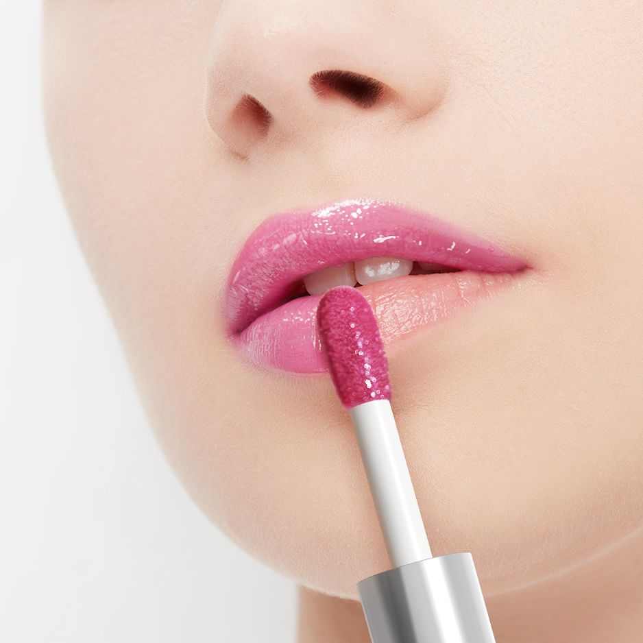 Close-up of a person applying pink lip gloss with a applicator.