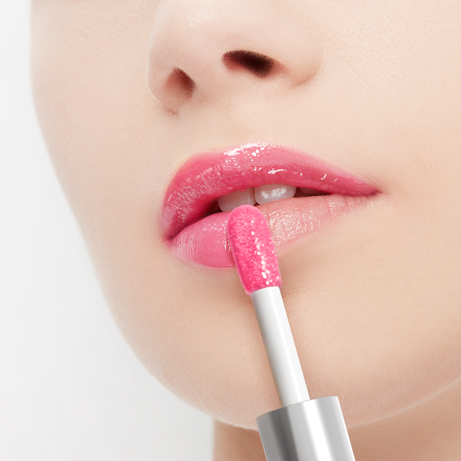 Close-up of a person applying pink lip gloss with a applicator.