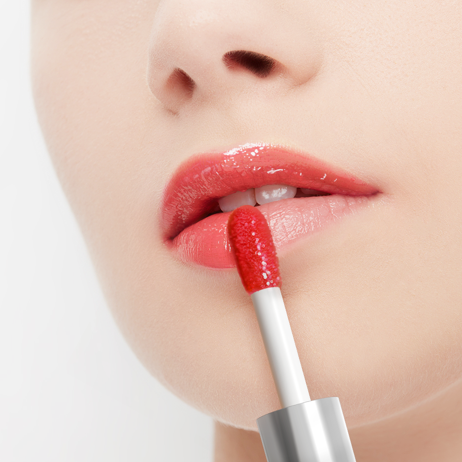 Close-up of a person applying red lipstick with a silver applicator.