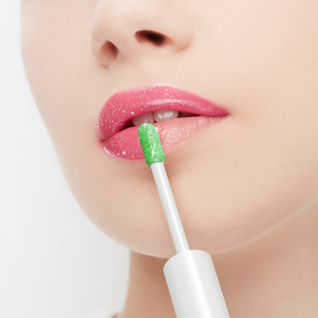 Person applying pink lip gloss with a green applicator on a white background