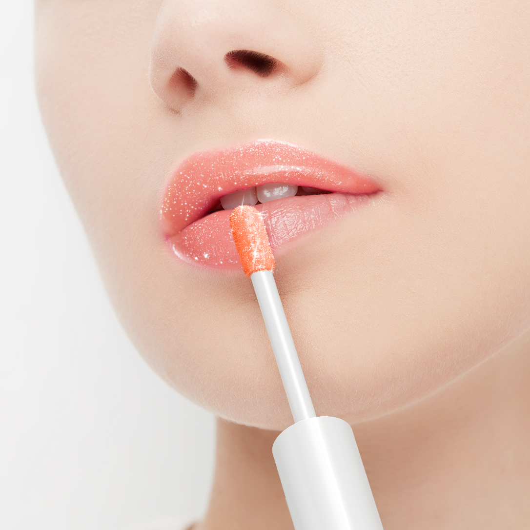 Person applying lip gloss with a brush on a white background