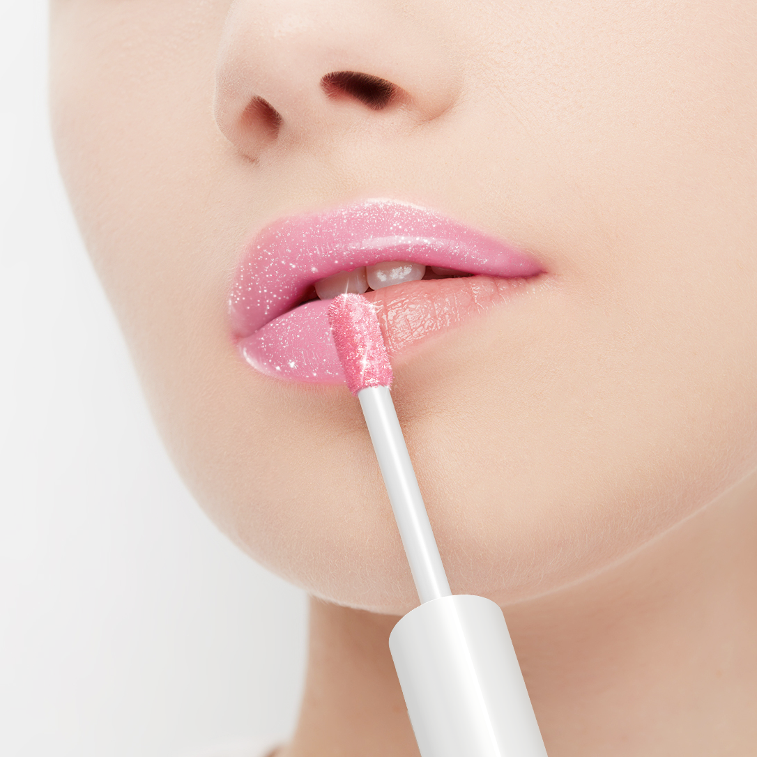 Person applying pink lip gloss with a applicator on a white background