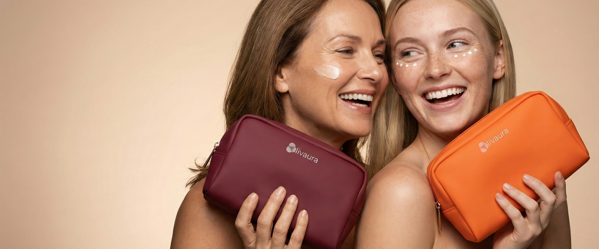 Two women holding a purple and an orange beauty bag against a beige background